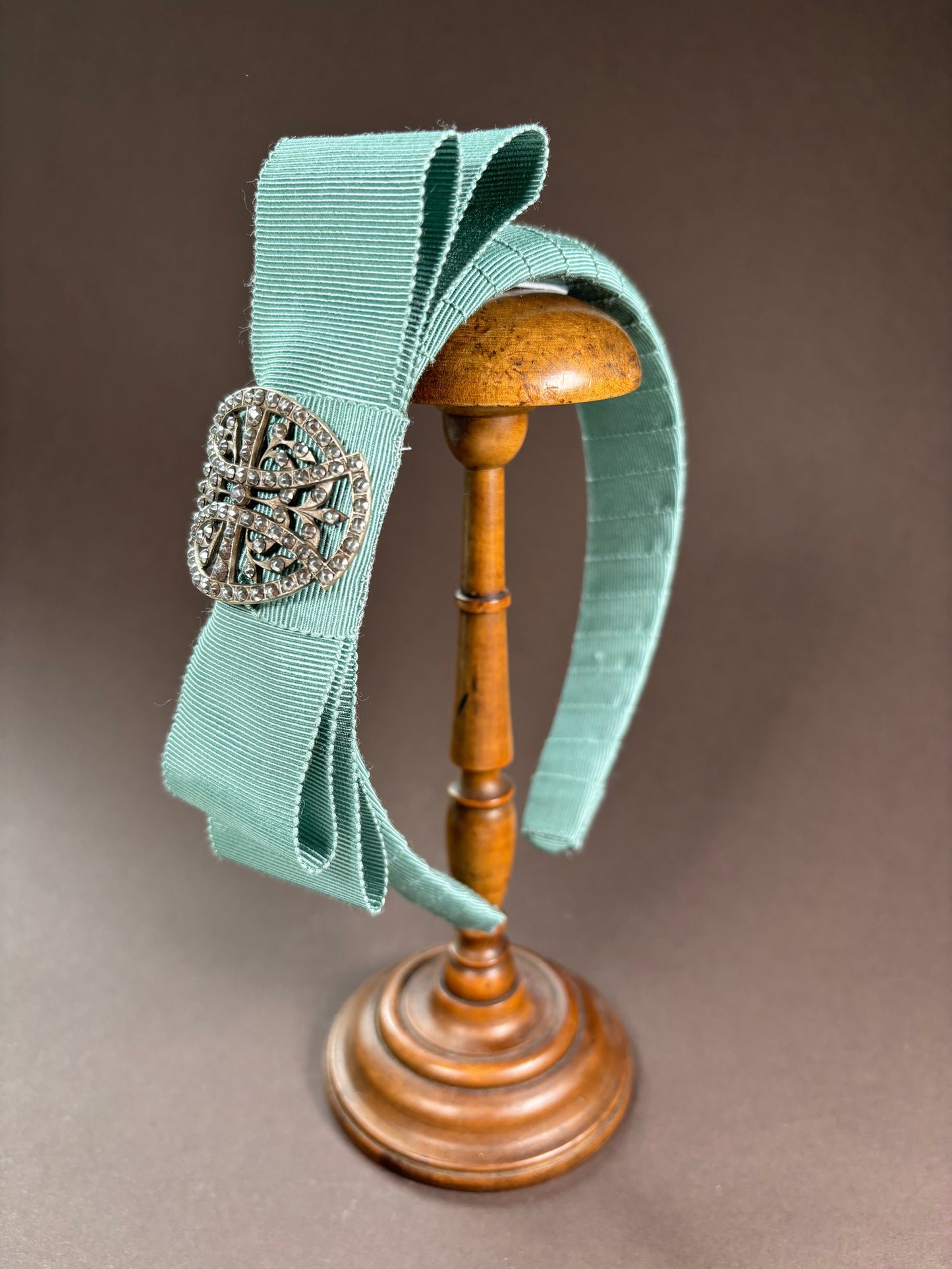 Headband in powdery turquoise with an exquisit antique brooch