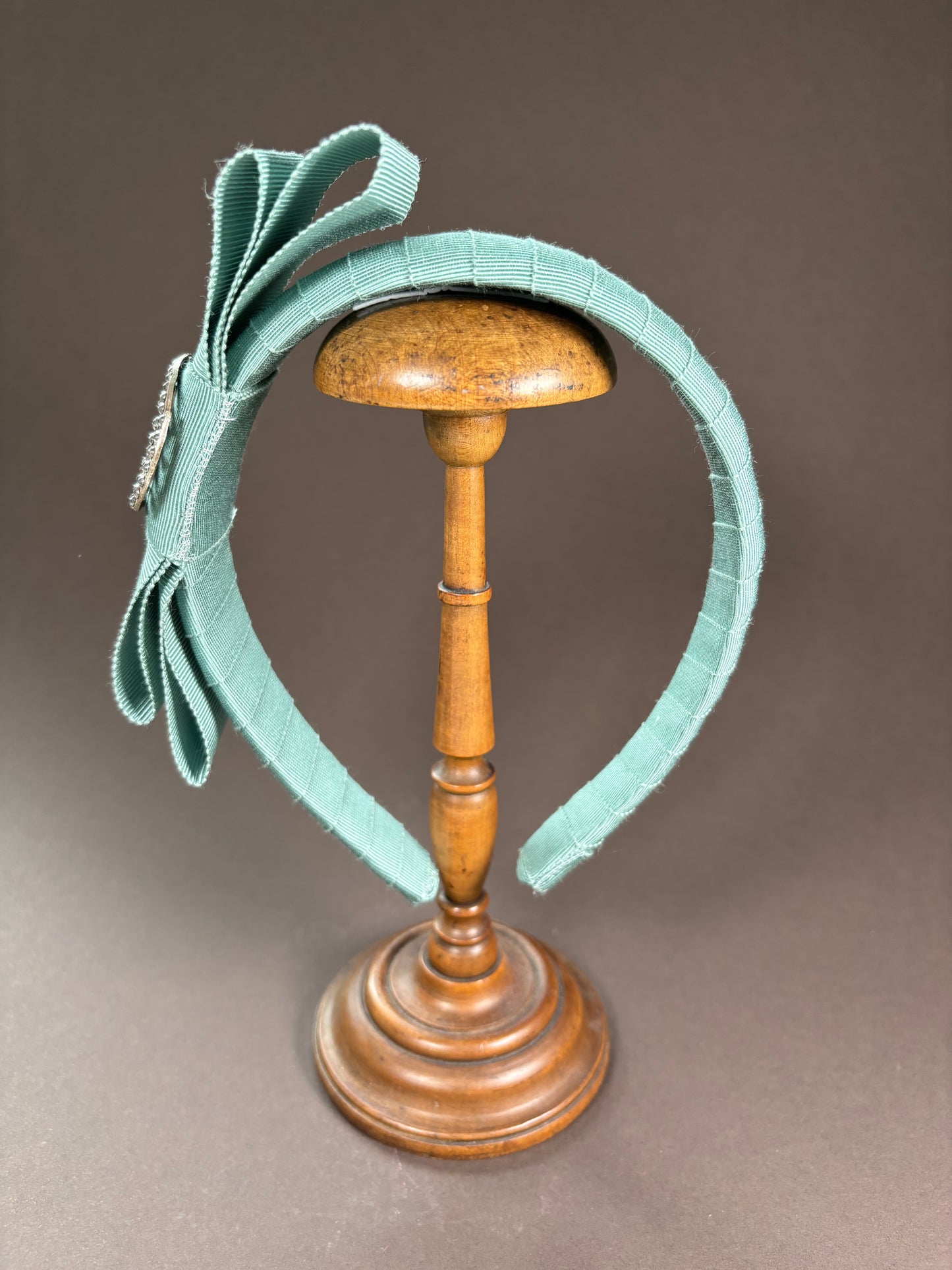 Headband in powdery turquoise with an exquisit antique brooch